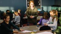 Burgum Scholar Olivia Dwyer works with students in the Badlands Elementary School library. 