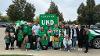 Staff from the UND Alumni Association & foundation pose with their float for the Homecoming Parade