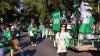 Staff from the UND Alumni Association & foundation walks with their float in the Homecoming Parade 