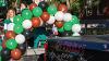 Staff from the College of Nursing & Professional Disciplines walks with their float in the Homecoming Parade 