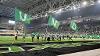 UND Spirit Squad members run across the field with UND Flags.