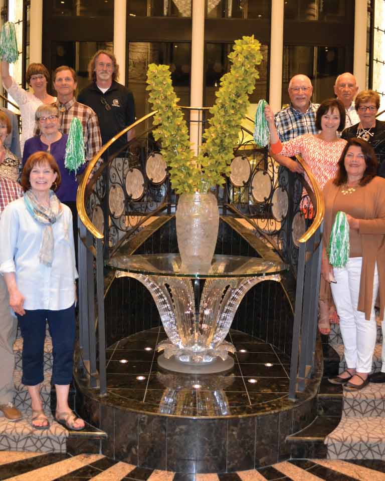 UND Alumni in front of Grand Staircase on a Cruise Ship