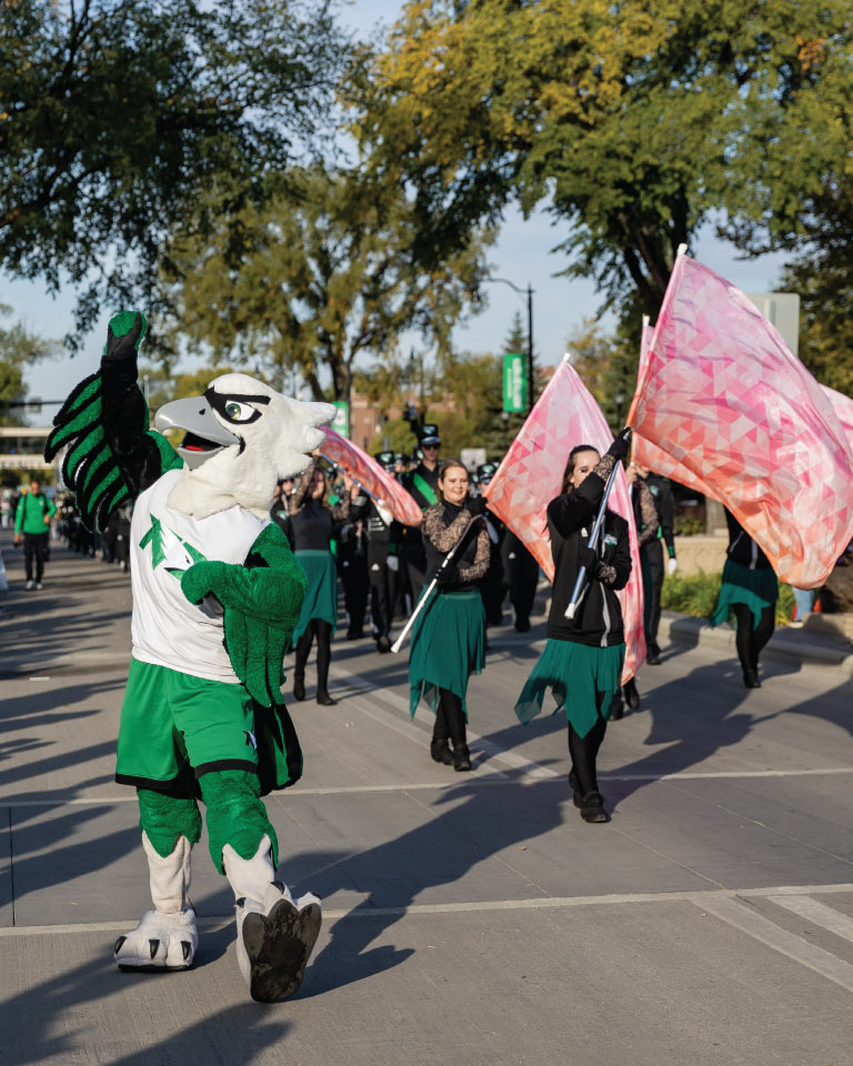 Fighting Hawk Mascot and color guard  in Homecoming Parade