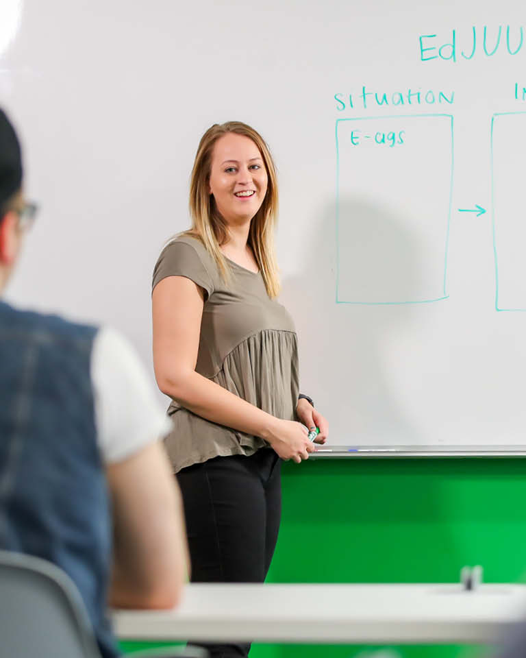 Student teacher at white board