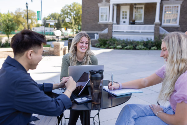 Grad students studying outside