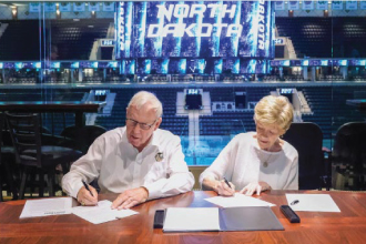 Bob and Jeanine signing a gift agreement