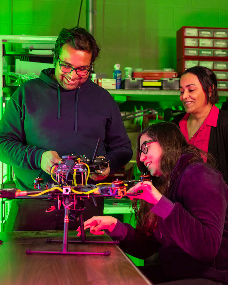 three students in cybersecurity lab