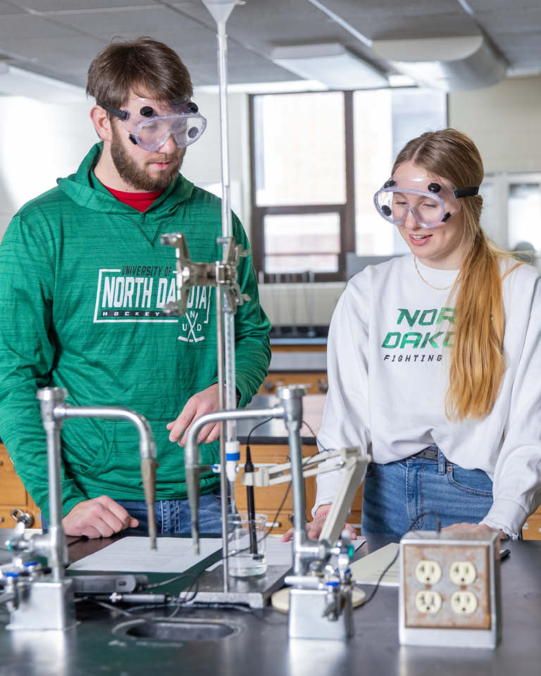 three students in a lab