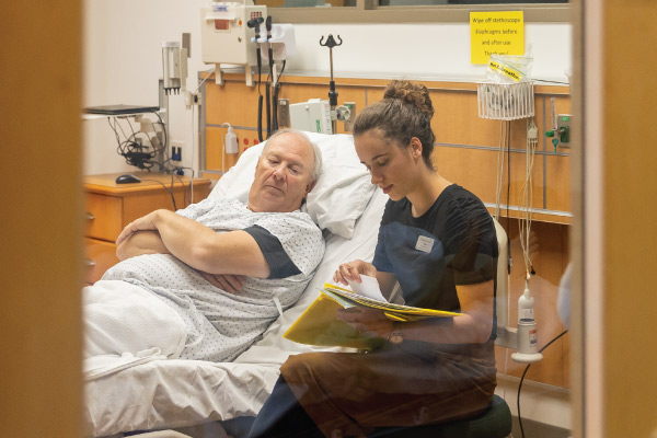 Nursing student working with a patient