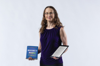 Dr. Virginia Clinton-Lisell holding a book and digital device