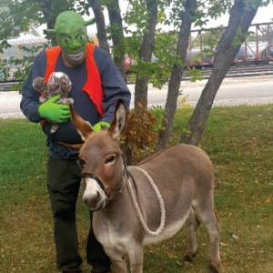 Mike dressed as Shrek with a donkey