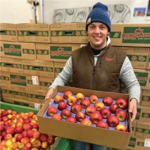 Alex with a case of the honeycrisp apples