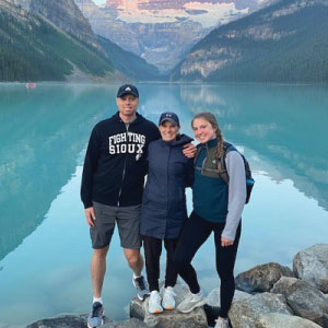 Lorine, Rob, and Anna in front of a mountain