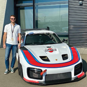 davide callegari standing by porsche car