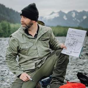 job solberg holding classroom chart in the outdoors