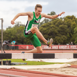 justin jelaca jumping over a hurdle