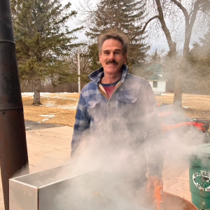person stands behind steaming syrup