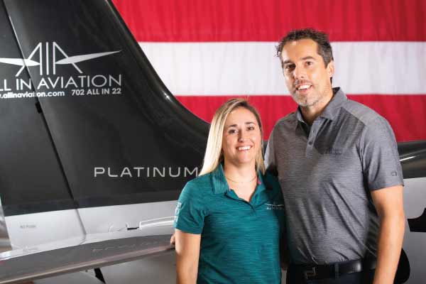 Paul and Lindsay Sallach in front of an aircraft