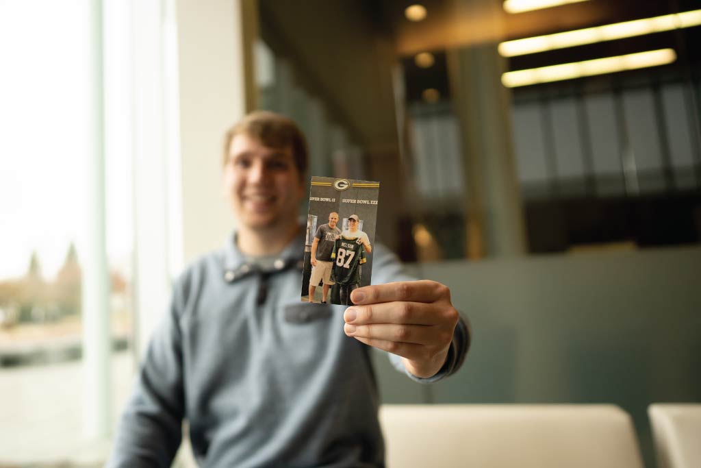 Tyler holding a photo of him with Jordy Nelson