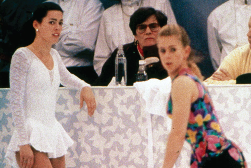 figure skaters on the ice in front of the judges