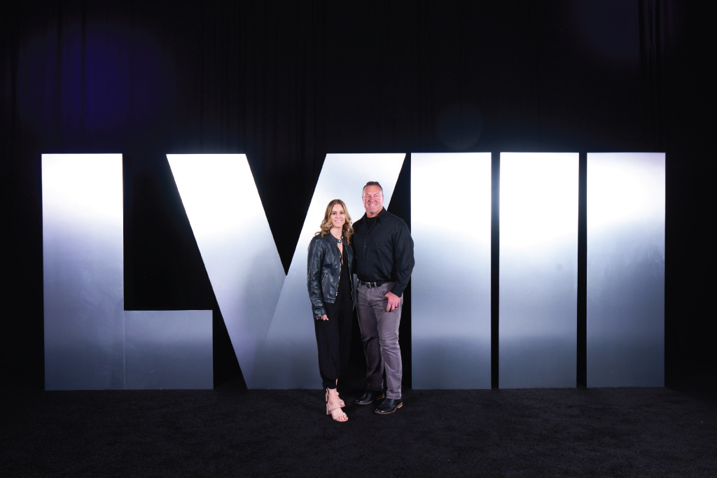 two people stand in front of lvii