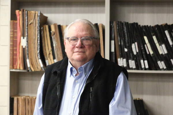 Fred Bartz pictured in front of library shelves