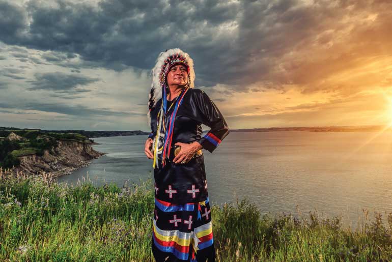 Dr. Monica Mayer pictured in traditional Native American regalia 
