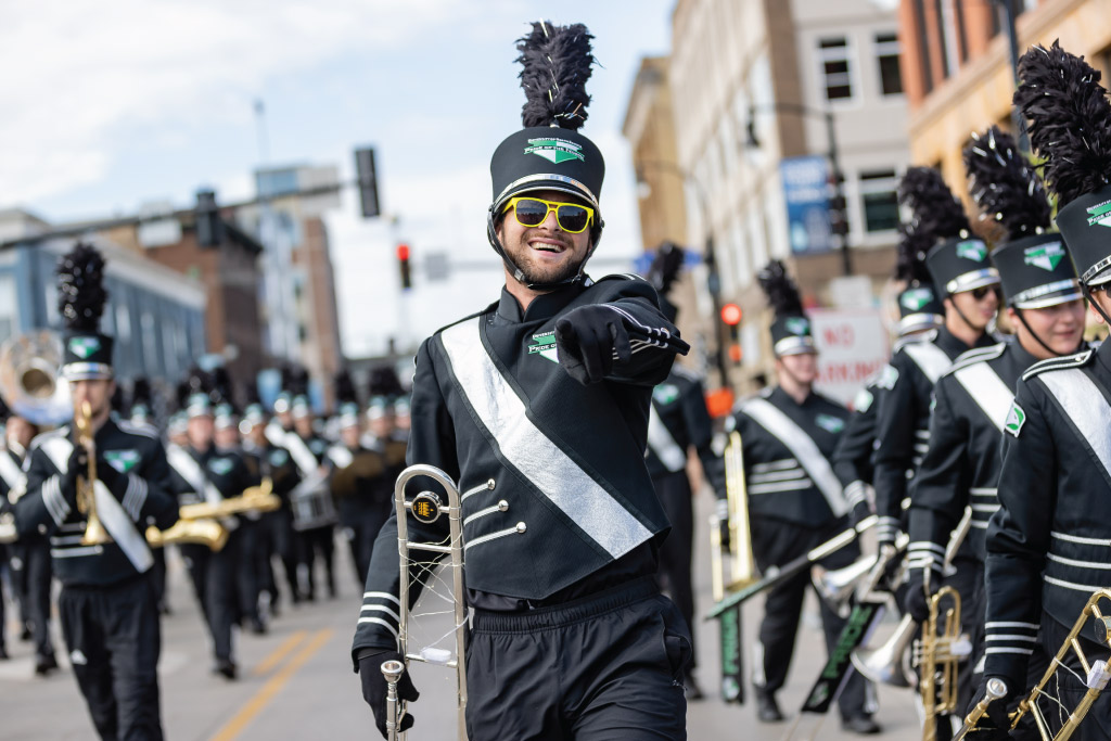 Pride of the North trombone player marching in a parade