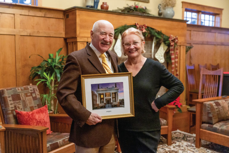 Dr. Kathleen and Hal Gershman with a photo of the Gershman Graduate Center