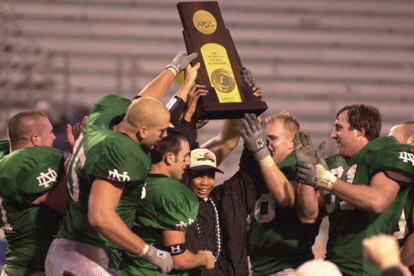 Group of football players holding trophy