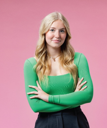 person wearing green shirt on pink background