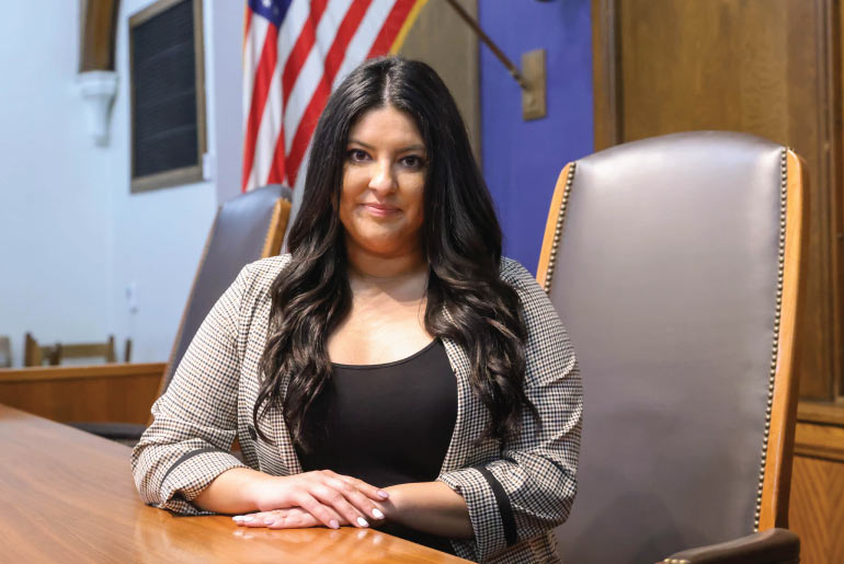 Priscila Ulloa sits in a court room, ready to practice law