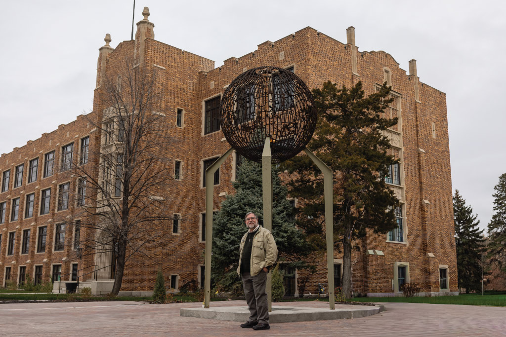 Sam Johnson in front of eternal flame