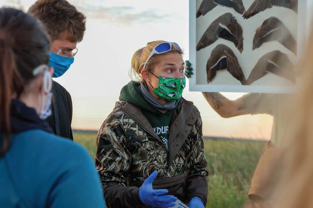 Dr. Dr. Susan Ellis Felege instructing students in a field. 